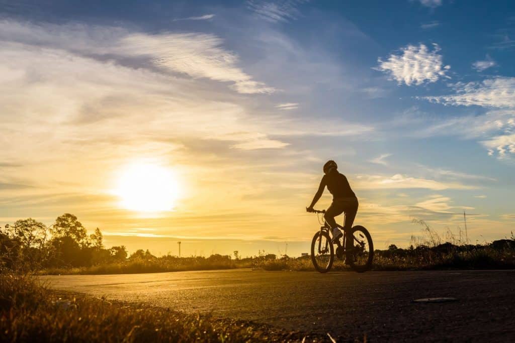 person biking at sunset